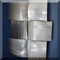 D16. Two pieces woven metal wall art. 